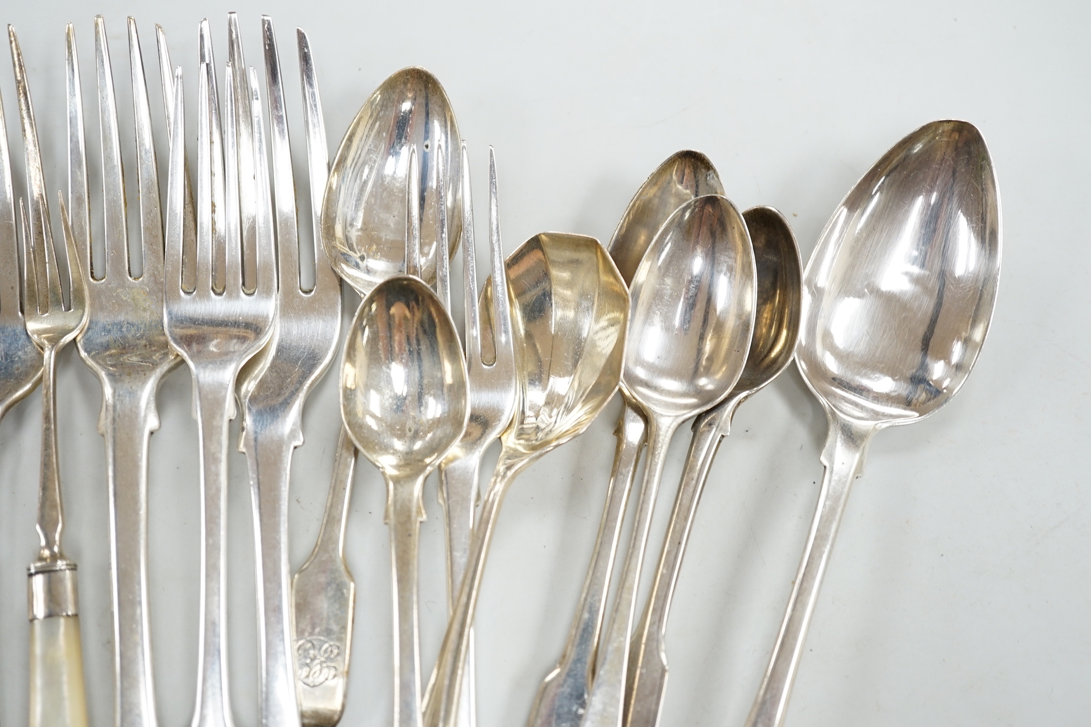 A George III silver Old English feather edge dessert spoon, London, 1775 and a small quantity of assorted mainly 19th century silver flatware including an Irish table fork, various patterns, makers and dates, 18.5oz.